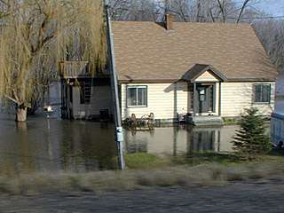 looking to the east from the road, the river threatens this house 4/15/01